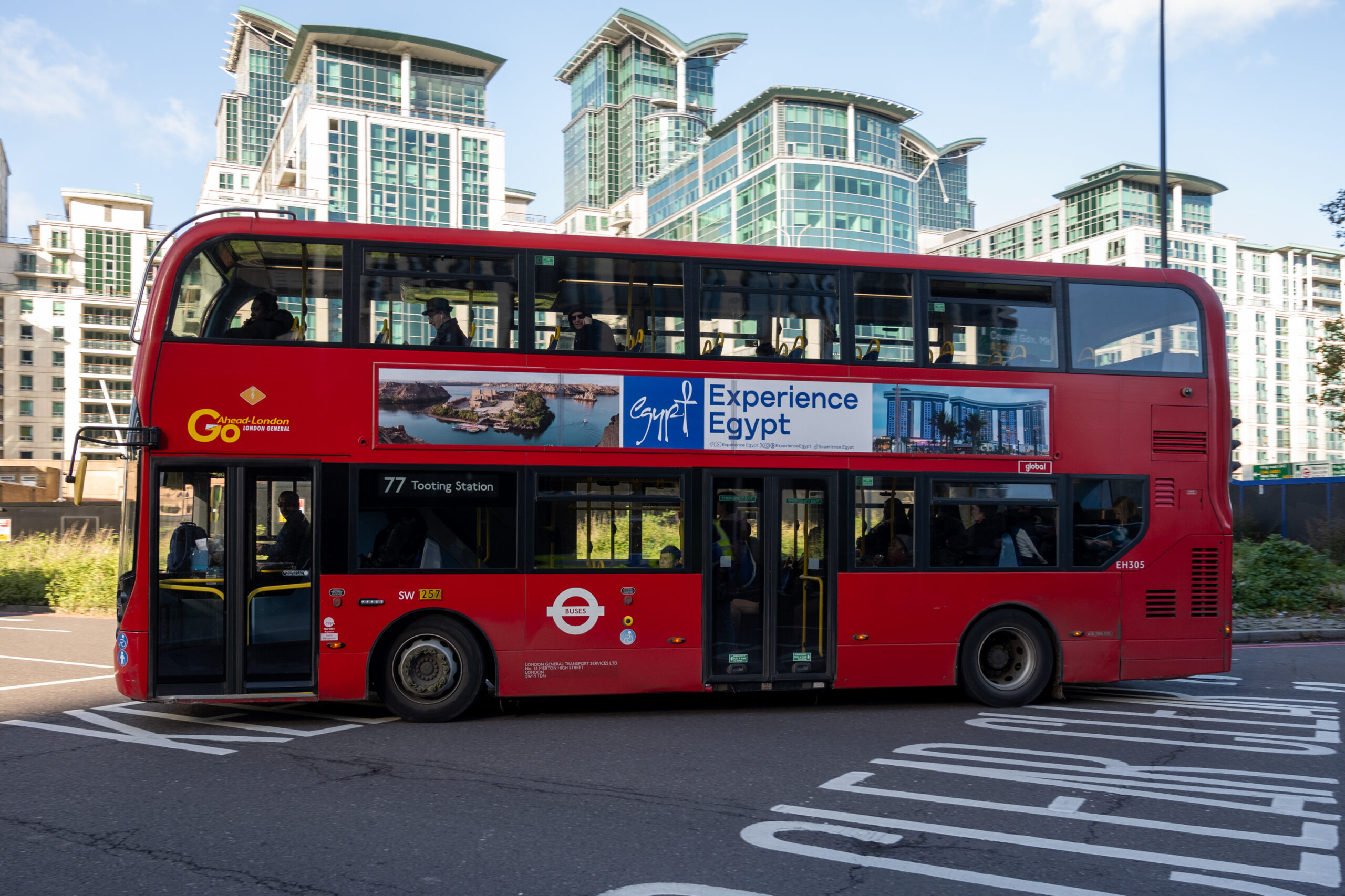 Bus advertising promoting a travel destination in an urban environment