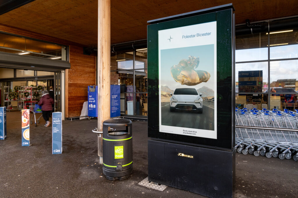Retail media advertising screen positioned at street level near retail locations influencing shoppers close to purchase