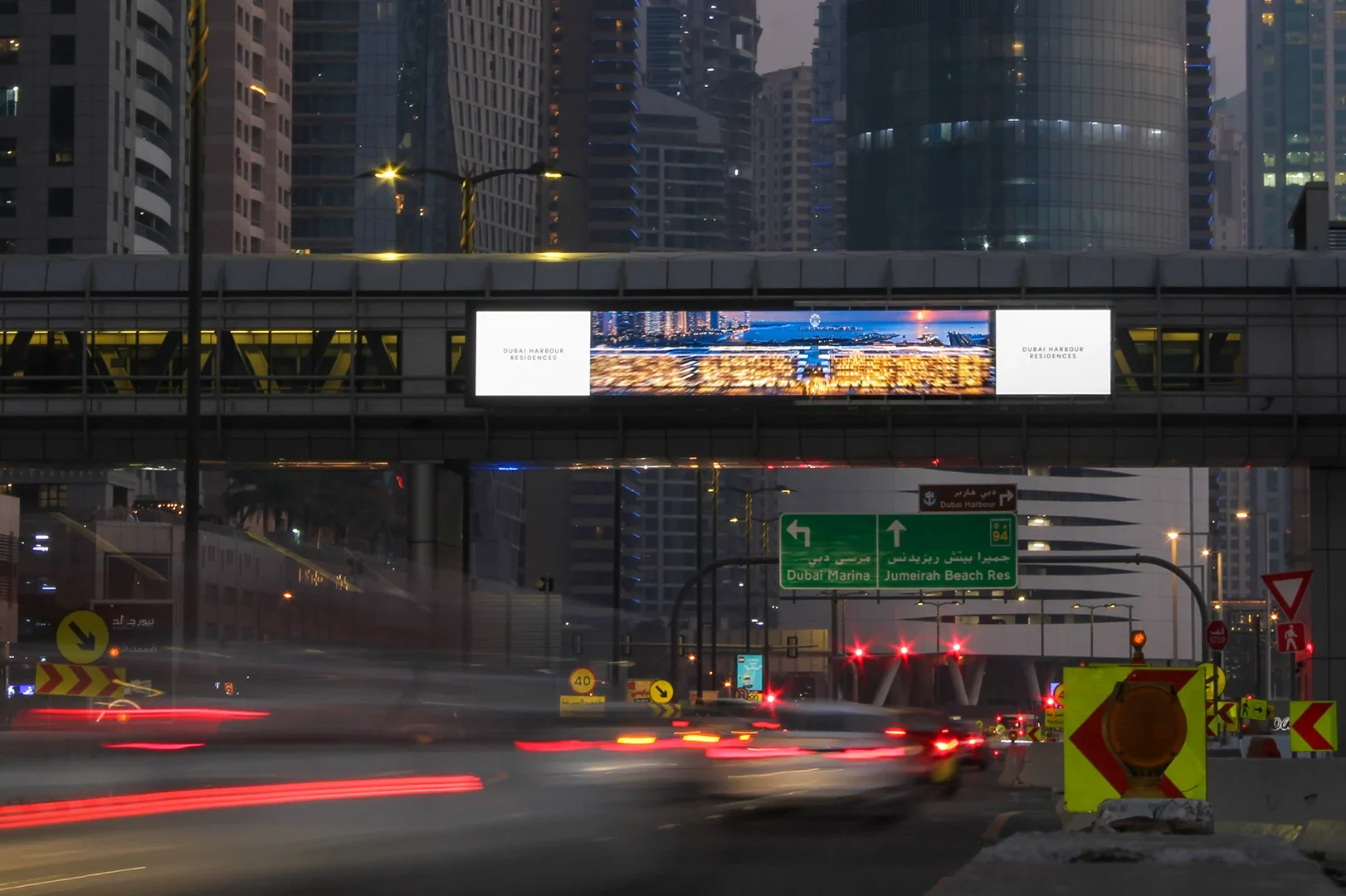 Bridge banner advertising across a busy road in Dubai