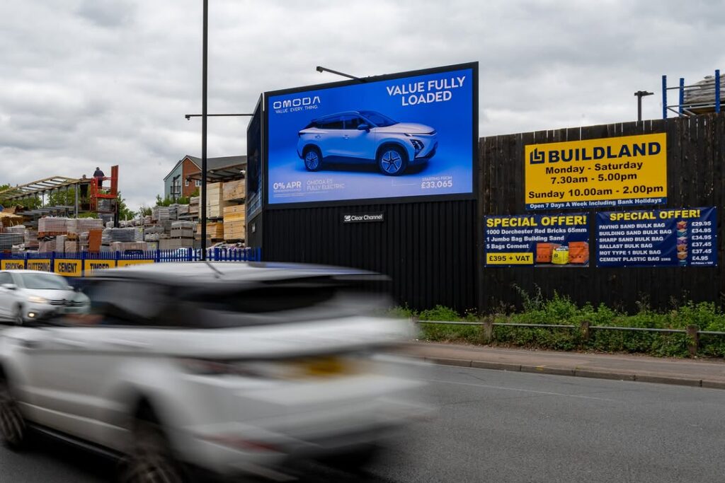 Car advertising campaign on a high-traffic roadside digital billboard