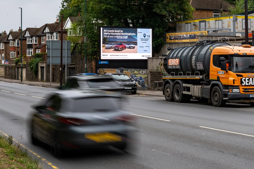 Roadside automotive advertising reaching drivers on major arterial routes
