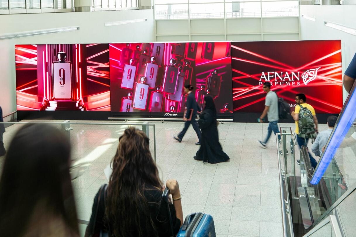 Airport advertising screens inside Dubai International Airport terminal