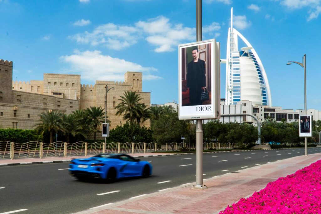 Roadside billboard advertising in Dubai city centre with Burj Al Arab in the background