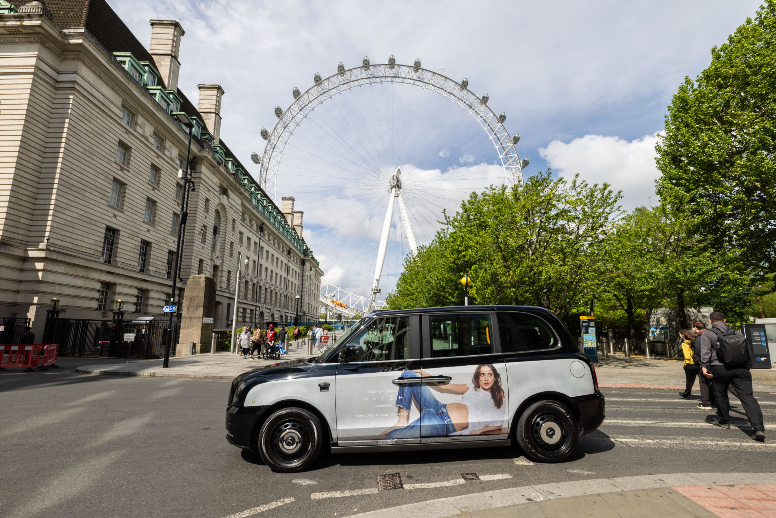 London taxi advertising campaign driving past the London Eye