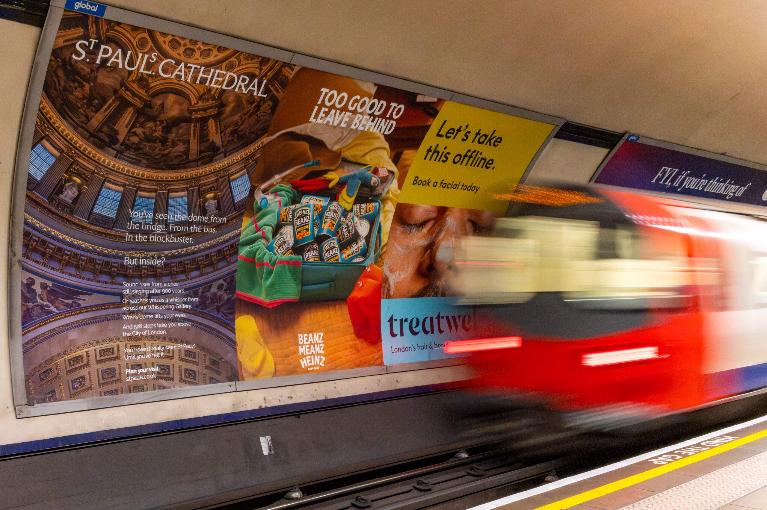 Cross Track Tube advertising opposite a London Underground platform
