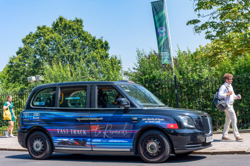 Fully wrapped Hyatt Hotels London taxi travelling through central London
